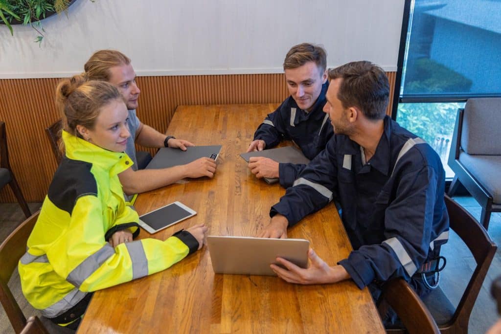 A safety meeting includes discussing completing incident reports as shown.