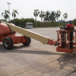 A worker tests a boom lift as part of a vehicle and equipment pre-use safety inspection.