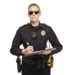An officer reluctantly holds a use of force report form.