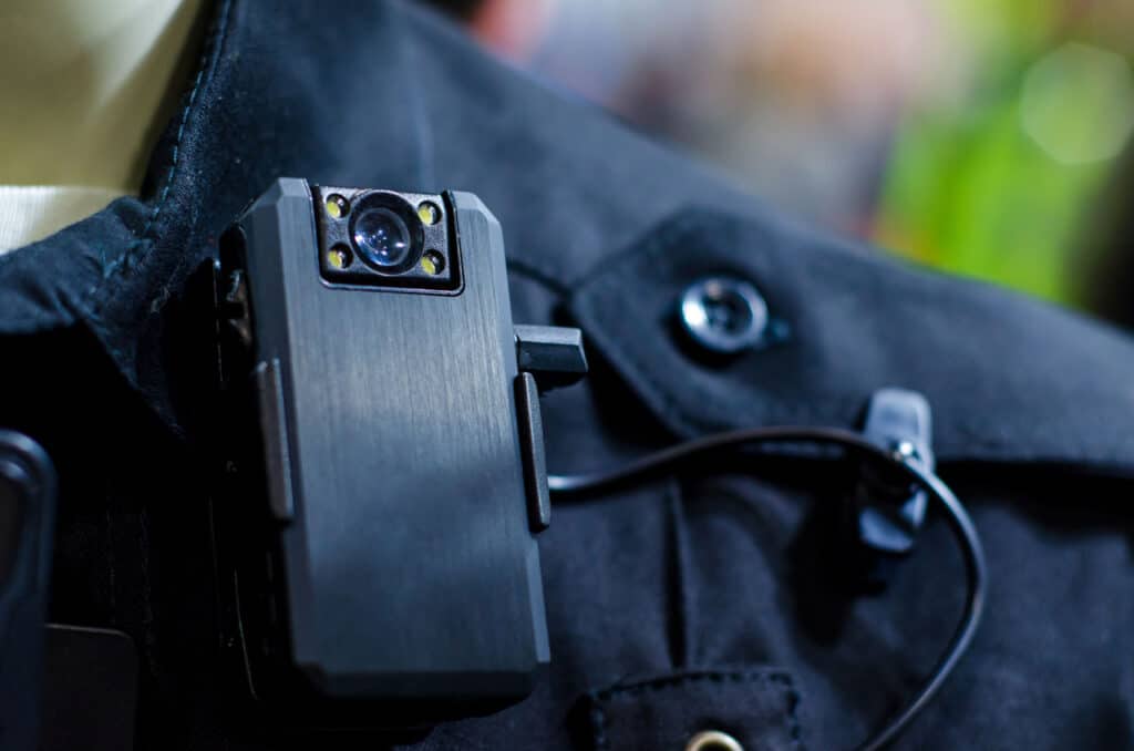An officer's mobile communications device is visible.