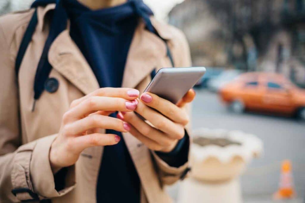 A property manager reads a property inspection report on her mobile device.
