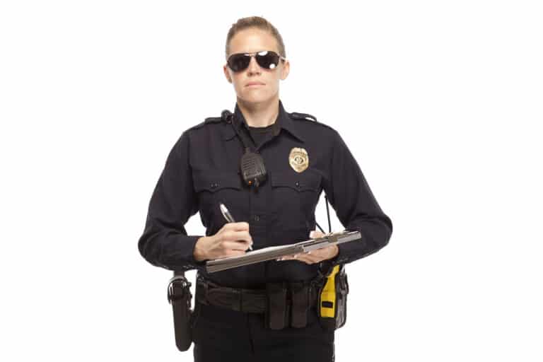 An officer reluctantly holds a use of force report form.