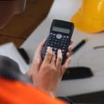 A safety officer uses the incident rate formula on a computer.