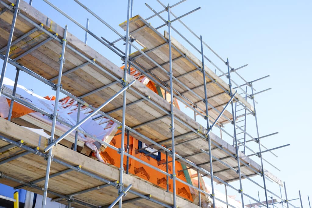 Scaffolding planks and decking at a construction site.