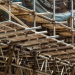 A scaffold inspection checklist is used to maintain scaffolding like the wooden scaffold shown.