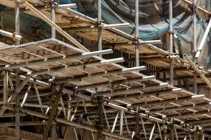 A scaffold inspection checklist is used to maintain scaffolding like the wooden scaffold shown.