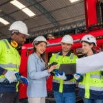 An engineer shows her team how to use the emergency action plan checklist on mobile devices.