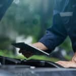 A man completes a commercial vehicle condition report on a mobile tablet.