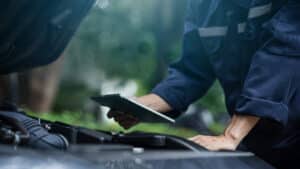 A man completes a commercial vehicle condition report on a mobile tablet.