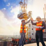 Two construction workers are proud to have safety topics for construction meetings handled.