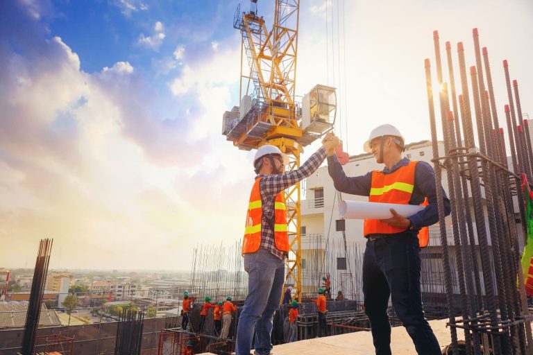 Two construction workers are proud to have safety topics for construction meetings handled.