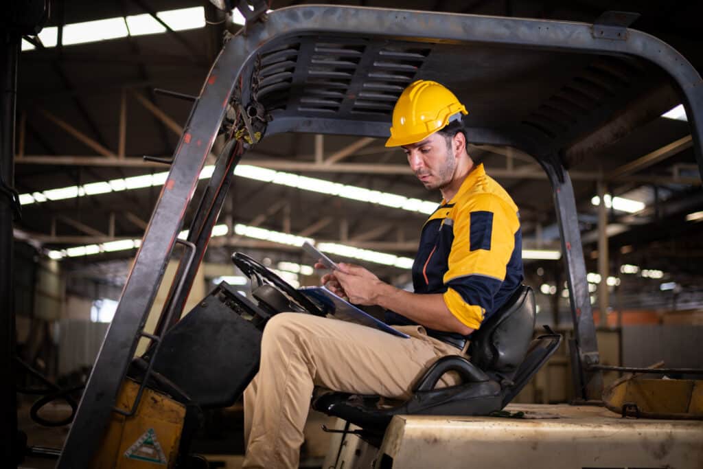 A forklift driver uses a custom digital checklist for forklift inspection on his mobile device.