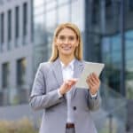 An agent happily uses a real estate listing checklist on a tablet.