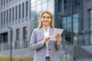 An agent happily uses a real estate listing checklist on a tablet.