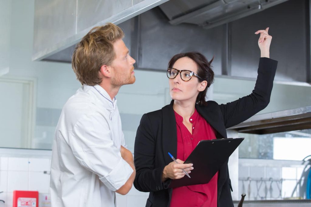 An inspector utilizes a Restaurant Health Inspection Checklist for the restaurant audit.