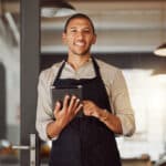A restaurant manager uses a restaurant health inspection checklist on a mobile device.