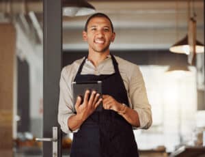 A restaurant manager uses a restaurant health inspection checklist on a mobile device.