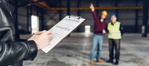 A manager completes a Site Visit Report template by 1stReporting.com.