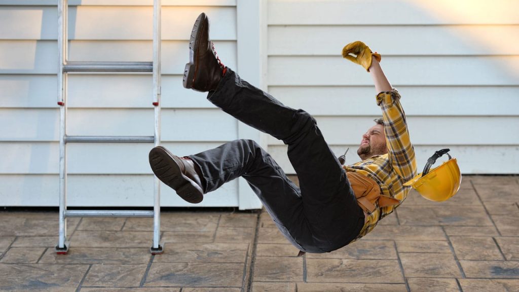A worker falls from a ladder in this image. Using 1st Reporting can help to avoid such mishaps.
