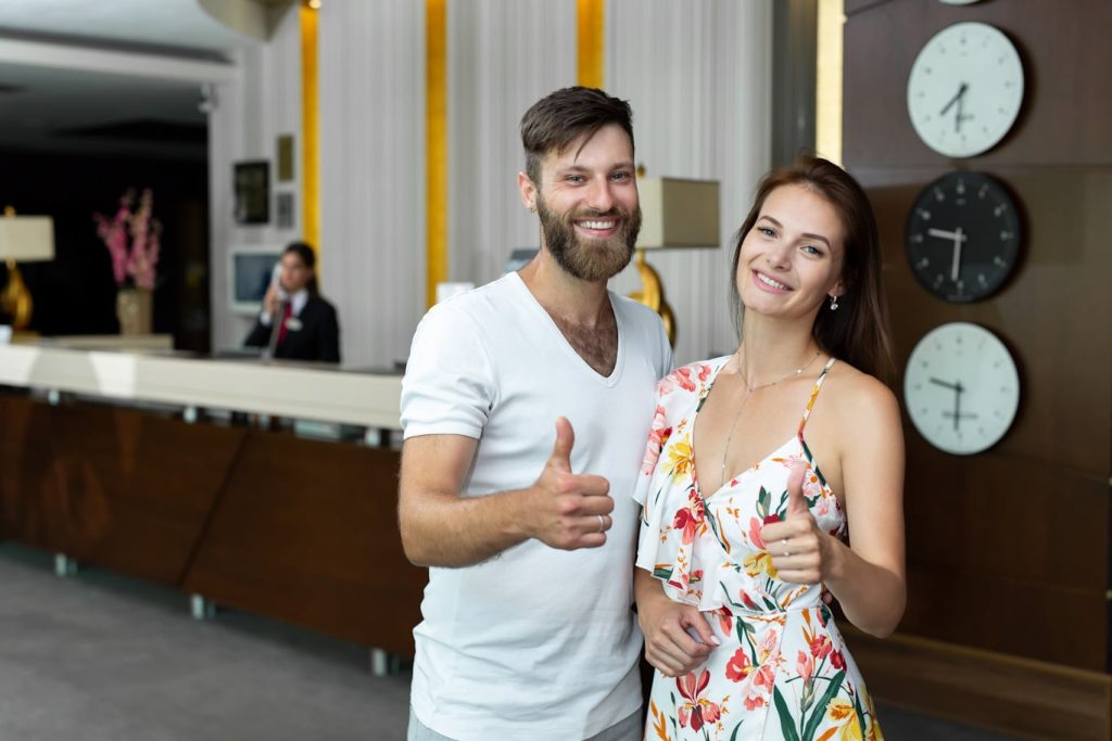 A young couple gives approval of  the quality of the hotel they are visiting. Learn more about hospitality industry mobile reporting at 1stReporting.com.