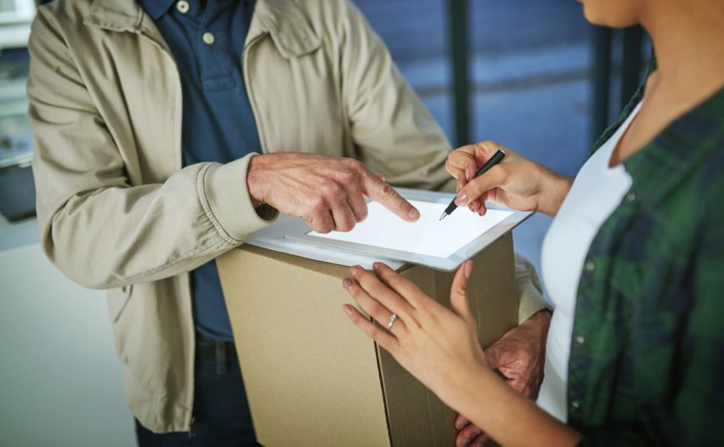 A woman signs off on a shipment that was damaged using the 1st Reporting application. Using a digital cargo damage report on a mobile device is the most effective way to document cargo shipment damage. Learn more about mobile reporting for logistics and other industries at 1stReporting.com.