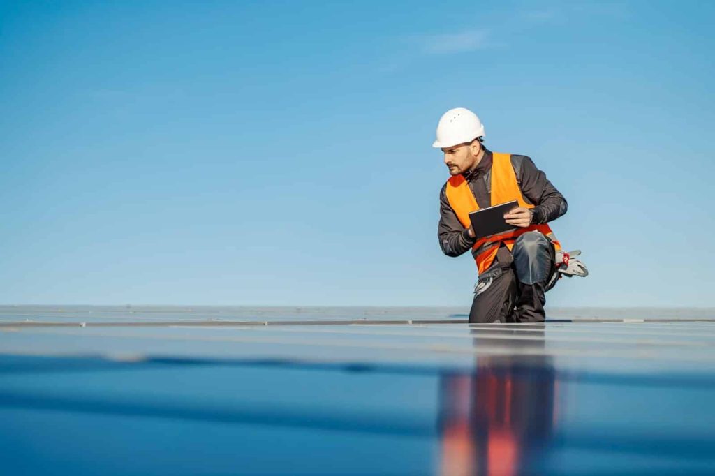 During a rooftop inspection, a rooftop inspector makes observations using the 1st Reporting App on his tablet.