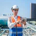 An engineer uses a daily field report template on his mobile tablet.