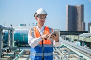 An engineer uses a daily field report template on his mobile tablet.