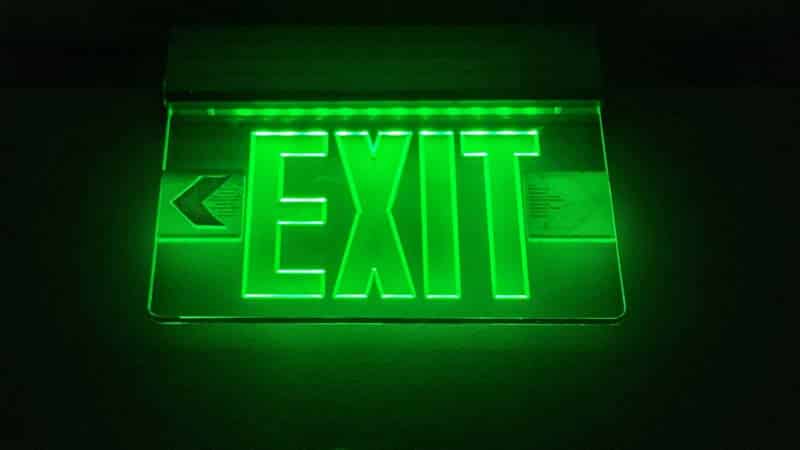 A lit exit sign shows in this file photo. Learn about exit sign requirements at 1stReporting.com.