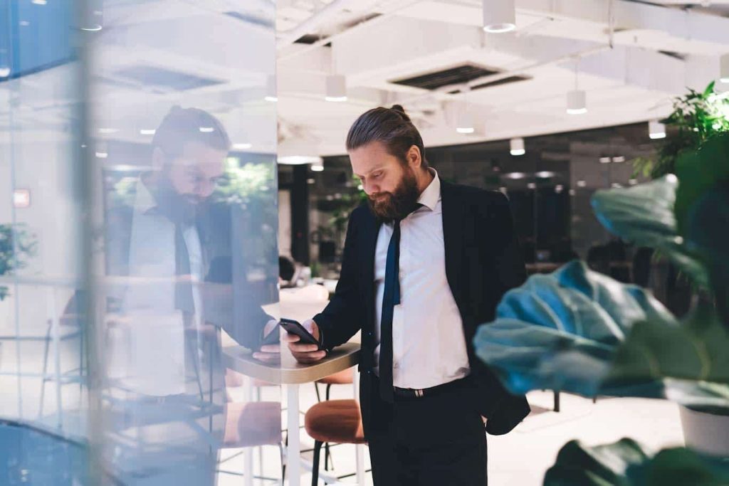 A security manager reviews a building security checklist and report in real time on his smartphone. Using the 1st Reporting app can offer you the same luxury. Learn more at 1stReporting.com.