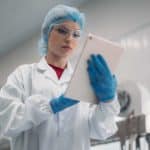 QC manager checks the Quality Control Checklist on a mobile device (tablet).