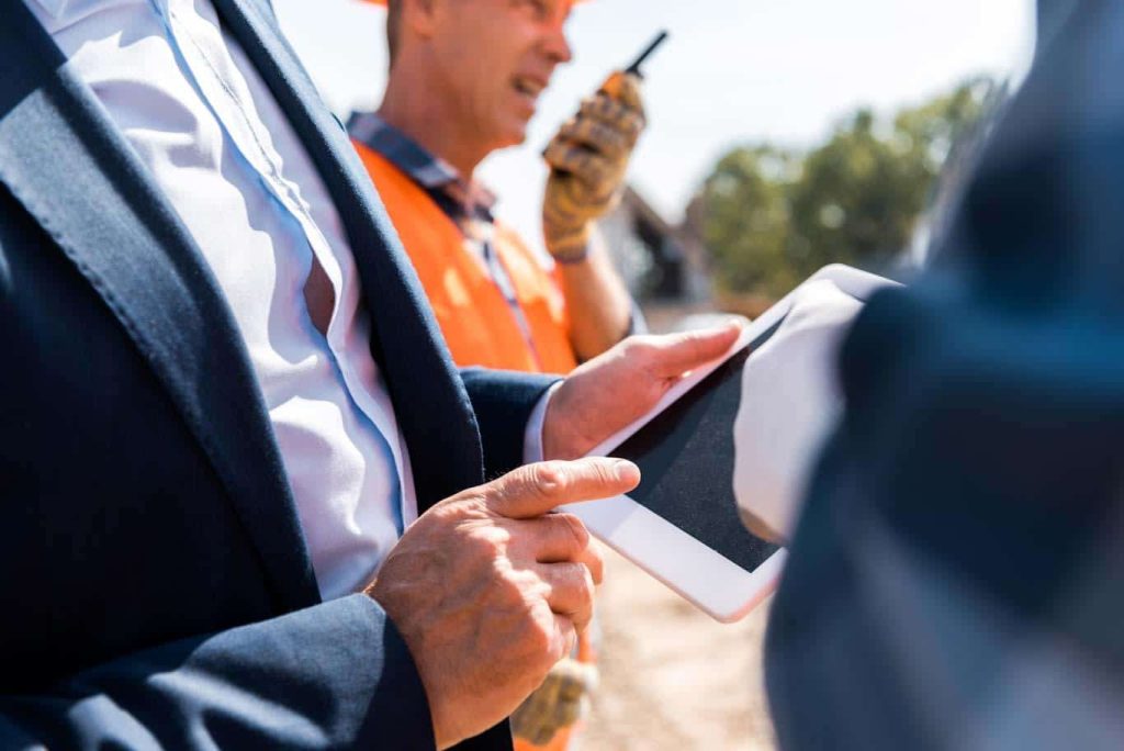 A manager uses a tablet to access a digital compliance checklist.