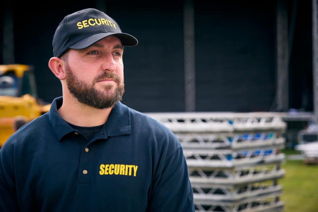 A security guard at an educational facility outdoor stage.