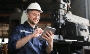 A maintenance worker leveraging mobile technology for predictive maintenance in asset management. Learn more about mobile reporting for maintenance at 1stReporting.com.