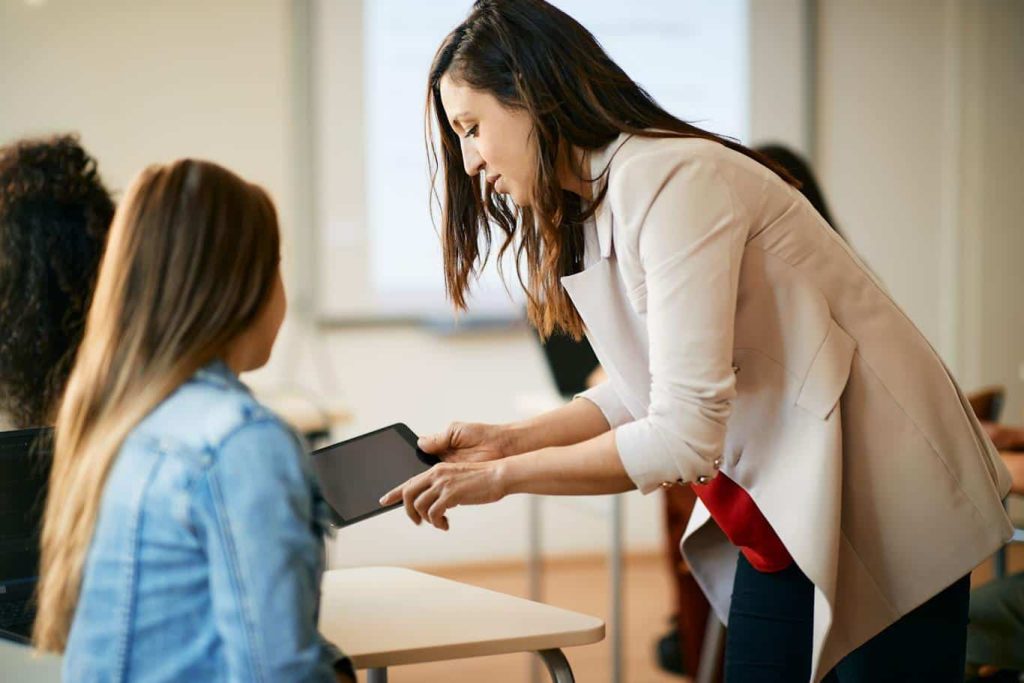 A teacher uses real-time reporting on a tablet to reduce response times in school emergencies. Learn more about mobile reporting in education at 1stReporting.com.