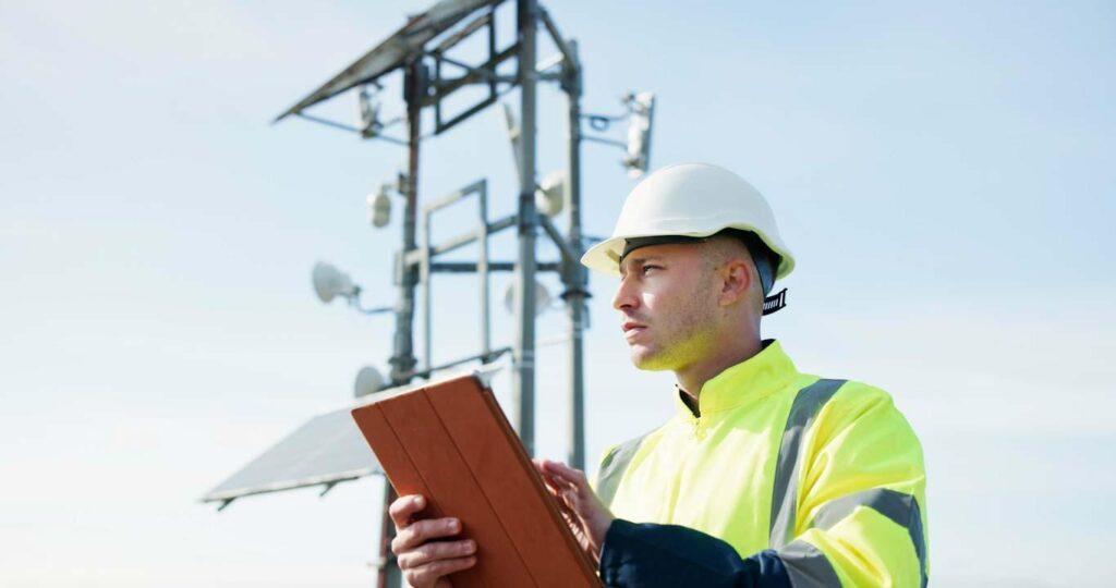 An electrical utilities worker uses a tablet with a digitized workflow in the 1st Reporting application for best practices in meeting compliance regulations. Learn more about field reporting in utilities at 1stReporting.com.