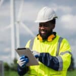 A utility technician uses a tablet to complete an asset management report following scheduled maintenance. Learn more about field mobility in reporting, scheduling, and managing assets, inspections, incidents, and events in utilities at 1stReporting.com.