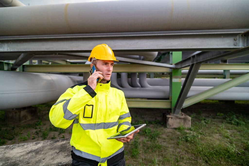 A utility worker completes a PdM using digital reporting tools.