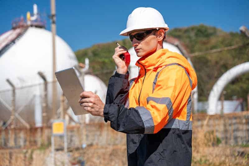 A utility field technician reports on the radio regarding his emergency response reporting using a mobile tablet.