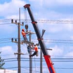 Three electricians work at remote utility sites requiring offline reporting tools.