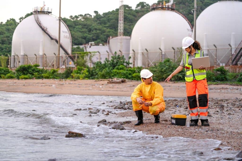 Two inspectors at a gas storage facility use mobile reporting for recording environmental study observations.