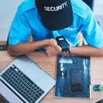 A security officer talks to another officer about retail incident reporting for security.